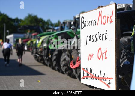 Aurich, Deutschland. 10. Juni 2023. Am Rande der Veranstaltung ist ein Schild mit der Aufschrift „Bauernmord geschieht lokal“ an einem Traktor angebracht. Die Vereinigungen Land schafft Verbindung (LSV) Ostfriesien und der friesische Naturschutzverband (FVN) haben eine Demonstration gegen die aktuelle Wolfspolitik gefordert. Kredit: Lars Penning/dpa/Alamy Live News Stockfoto