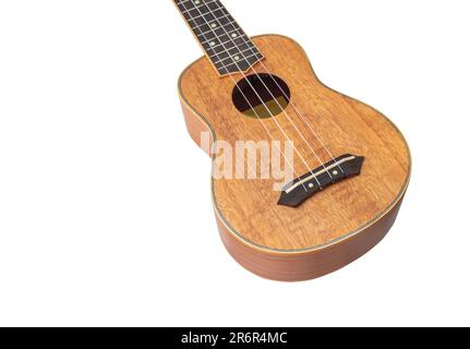 Ukulele Hawaii-Gitarre auf weißem Hintergrund, Magier aus Okoume-Holz, selektiver Fokus Stockfoto