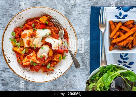 Sizilianischer Fisch mit Pfeffersoße und Süßkartoffelchips Stockfoto