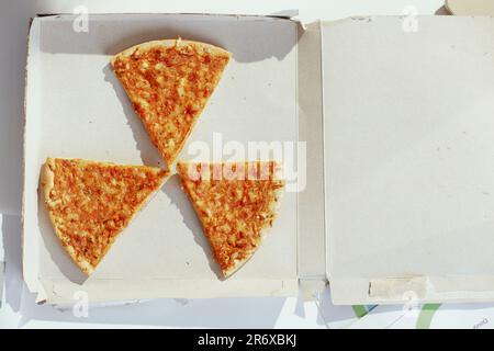 Blick von oben auf Pizza am Tisch im Strahlenschild. Stockfoto