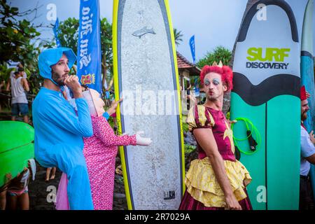 Surfen in Karnevalskostümen, Bali, Indonesien. Stockfoto