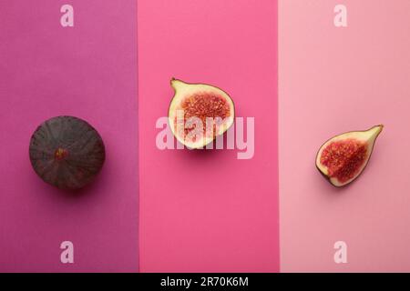 Frische reife Feigen auf farbenfrohem pinkfarbenen Hintergrund. Draufsicht. Stockfoto