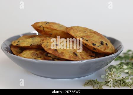 Daal Poor mit Moringa-Blättern. Frittiertes indisches Fladenbrot aus Vollweizenmehl, gekochten Linsen und Moringa-Blättern und Gewürzen. Auf weißem Ba geschossen Stockfoto