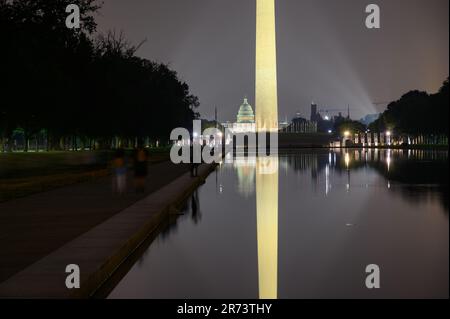 Das Washington Monument und das US Capitol Building spiegeln sich nach Einbruch der Dunkelheit im reflektierenden Pool entlang der National Mall in Washington DC wider Stockfoto
