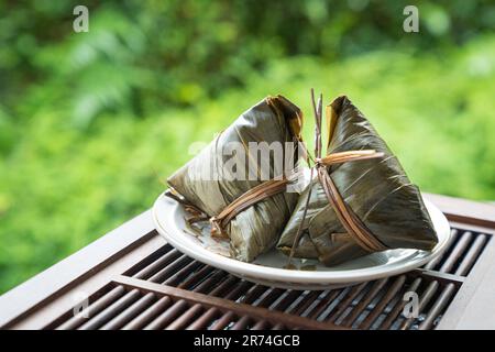 Zongzi. Reisklößchen für das traditionelle chinesische Bootsfestival, das Duanwu Festival. Speicherplatz kopieren. Stockfoto