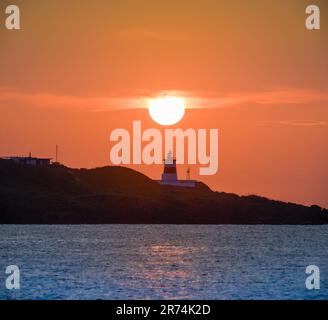 In der Dämmerung ist die Sonne über dem Leuchtturm. Das Fugui Cape Lighthouse in Shimen. Taiwan Stockfoto