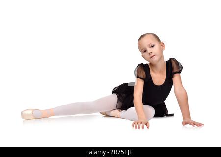 kleine Ballerina am Boden in schwarz tutu Stockfoto