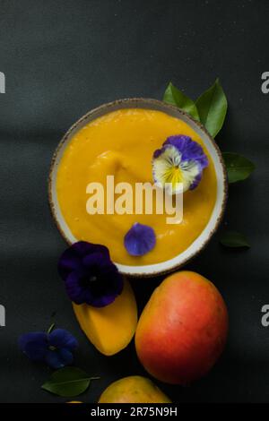 Mango Lassi, Smoothie-Schüssel mit Kurkuma. Frische tropische Früchte auf hellem Hintergrund. Gesundes Essen Stockfoto
