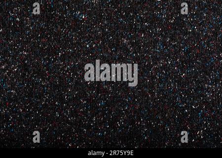 Bunte gepunktete Textildetails auf Schwarz. Stockfoto