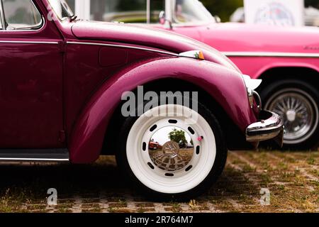 Izmir, Türkei - 3. Juni 2023: Nahaufnahme von Regentropfen auf dem rechten vorderen Kotflügel eines pinkfarbenen 1972 Volkswagen Käfers beim IZKOD Classic Car Meeting in Buca P. Stockfoto