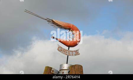 Unterschreiben Sie im Hafen von Greetsiel mit der Schreibweise Greetje unter der Skulptur einer Garnele oder Krabbe in Ostfriesien. Stockfoto