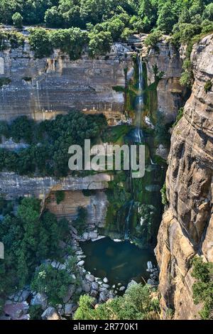 Ein großer, schöner Wasserfall inmitten von Felsen. Naturhintergrund. Stockfoto
