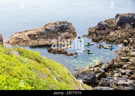 Kanufahrer machen eine Pause in der St Non's Bay auf der Halbinsel St. David's im Pembrokeshire Coast National Park, Wales, Großbritannien Stockfoto