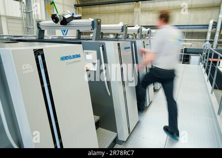 Wiesloch, Deutschland. 07. Juni 2023. Ein Mitarbeiter begibt sich auf einer Bogenoffsetdruckmaschine des Typs 21k im Hauptwerk der Heidelberger Druckmaschinen AG. Das Unternehmen gibt seine Geschäftszahlen für das vergangene Jahr am 14. Juni in Frankfurt bekannt. Kredit: Uwe Anspach/dpa/Alamy Live News Stockfoto