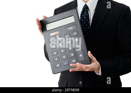 Asiatischer Geschäftsmann mit großem Taschenrechner Stockfoto