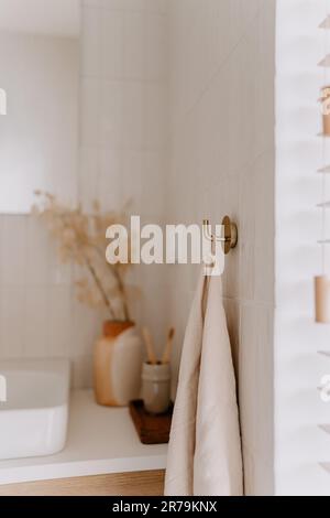 Eine weiße Badewanne im Badezimmer mit einem Spiegel, der sich im Hintergrund von der Wand reflektiert Stockfoto