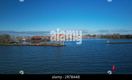 Am markermeer See, dem hölzernen Leuchtturm und dem Hafeneingang des goldenen Zeitalters des Stadthafens Hoorn Stockfoto