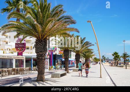 Apartments, Cafés und Restaurants auf der Avenue Infante de Sagres, Quarteira, Algarve, Portugal Stockfoto