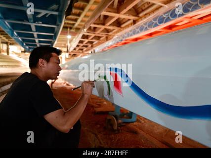 (230615) -- FUZHOU, 15. Juni 2023 (Xinhua) -- Ein Handwerker malt ein Drachenboot in Fangzhuang Village, Minhou County, Fuzhou City, südöstlich Chinas Provinz Fujian, 23. Mai 2023. Mit dem bevorstehenden Drachenbootfestival sind die Handwerker im Fangzhuang Village im Minhou County, Fuzhou City im Südosten Chinas, zunehmend beschäftigt. Die vier großen Drachenbootfabriken des Dorfes arbeiten unermüdlich daran, ihre Befehle für das bevorstehende Festival zu erfüllen. Jedes Jahr werden von hier aus über 200 Drachenboote in verschiedene Teile Chinas und Länder wie Japan, Singapur und Th verkauft Stockfoto