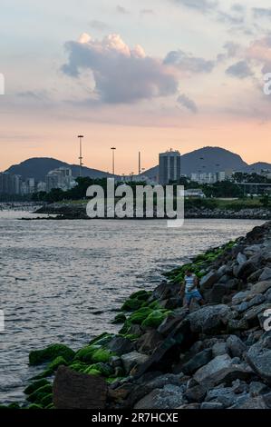 Blick am späten Nachmittag auf den Santos Dumont Rock Pier (Pier de Pedra) am Wasser der Guanabara Bay, nahe gelegener Flughafen Santos Dumont unter dem Himmel des Sonnenuntergangs im Sommer. Stockfoto