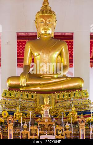 Large golden Buddha in lotus position in the Buddhist temple and monastery Wat Mahathat Yuwaratrangsarit. It is one of the 10 royal temples of the Stock Photo