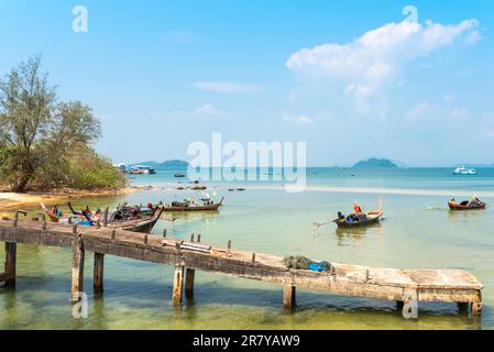 Einheimische am Strand und auf ihren Langbooten am Weststrand von Ao Mae Mai auf der Insel Ko Phayam in Thailand Stockfoto