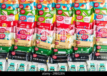 Bunte Auswahl verschiedener Gefälligkeiten japanischer Mini-zwei-Bar-Kit-Kats in Säulen, die von Kante zu Rand des Rahmens verlaufen. Stockfoto