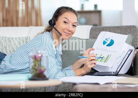 Schöne junge Frau, die von zu Hause aus arbeitet Stockfoto