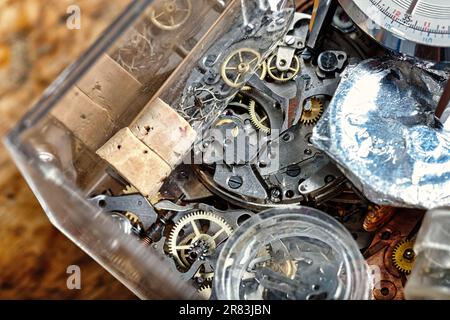 Ein Handwerkertisch mit Armbanduhren, Taschenuhren und komplizierten mechanischen Details. Eine Sinfonie von Präzision, Geschmack und Steampunk-Ambiente Stockfoto