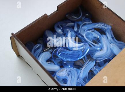White Wooden Case With Smooth Blue Glass Stones Detailed Angle View Stockfoto