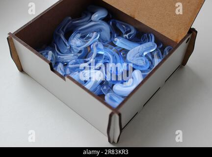 Blue Smoky Glass Stones Inside A Wooden Jewelry Box Isolated On White Stockfoto