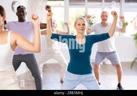 Ältere Frau tanzt Hip-Hop während des Gruppentanzkurses Stockfoto