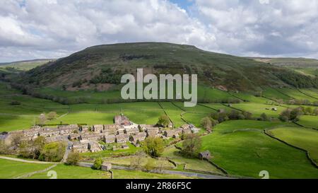 Im Frühsommer liegt das Dorf Thwaite am oberen Ende von Swaledale, hinter dem sich Kisdon Hill befindet. Yorkshire Dales National Park, Großbritannien. Stockfoto