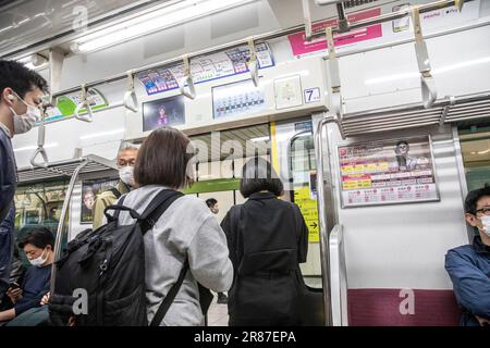 Tokio Eisenbahnnetz Pendler in einem Zug bereiten sich auf das Aussteigen vor, wenn sich die Türen öffnen, Japan, Asien 2023 Stockfoto