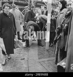 Aktuelle 13-7-1960: Wer hat geschossen? Ein Schuss kam aus dem Hotelzimmer im fünften Stock einer Farm in Richtung Karl-Johans-Tor. Im gleichen Moment brach ein Mann mittleren Alters auf einer Treppe die Straße runter zusammen, mit den Händen auf den Bauch gedrückt. Bevor er ohnmächtig wurde, beschwerte sich der 56-jährige Stationsvorarbeiter Nils Mathiesen über die Leute, die um ihn herum waren: Wer hat auf mich geschossen? Während die Ärzte um Mathiesen's Leben kämpften und die Leute sich beeilten, begannen die Ermittler mit ihrer gründlichen Arbeit. Nach sechs hektischen Stunden konnten sie die Frage beantworten. Foto: Ivar Aaserud / Aktuell / NTB ***FOTO NICHT IMAGE Stockfoto