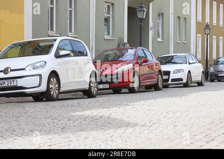 Strangnas, Schweden - 19. Juni 2023: Kleine, moderne Autos im Taschenformat, die auf Gehwegen auf Kopfsteinpflasterstraßen in einem Wohngebiet geparkt werden. Stockfoto