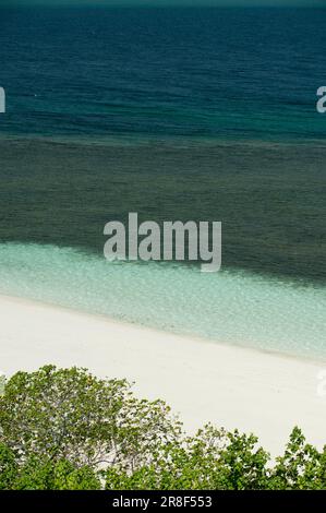 Christale Meereswellen brechen am weißen Sandstrand mit türkisfarbenem smaragdgrünen Wasser - Stockfoto Stockfoto