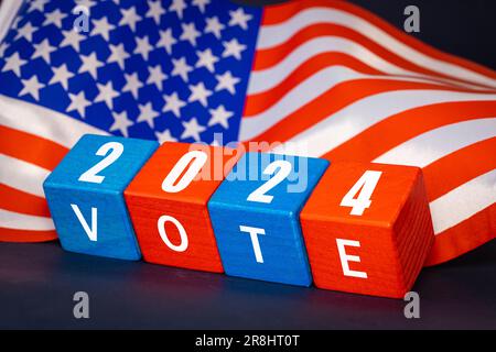Wahl 2024 in den USA, Abstimmung bei den Präsidentschaftswahlen in den Vereinigten Staaten, Konzept, Holzblöcke in den Nationalfarben der USA, Jahr und Stockfoto
