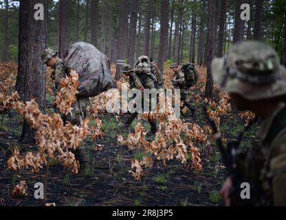 27. Mai 2023 - Hoffman, North Carolina, USA - Spezialeinsatzkandidaten für die USA Army John F. Kennedy Special Warfare Center and School Knie nieder, während sie in der letzten Phase des Feldtrainings, bekannt als Robin Sage, in der Mitte von North Carolina am 27. Mai 2023 durch ein bewaldetes Gebiet wandern. Robin Sage ist die Kulminationsübung für Soldaten im Qualifizierungskurs der Spezialkräfte und ist seit mehr als 50 Jahren der Lackmustest für Soldaten, die sich die Green Beret verdienen wollen. (Kreditbild: © K. Kassens/USA Army/ZUMA Press Wire Service) NUR FÜR REDAKTIONELLE ZWECKE! Nicht für gewerbliche VERWENDUNG Stockfoto