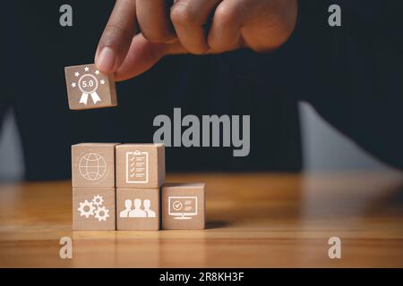 Der Finger eines Geschäftsmannes, der ISO-Holzwürfel drückt Stockfoto