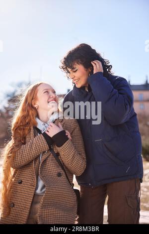 Glückliche, lächelnde Freundinnen, die sich anschauen Stockfoto