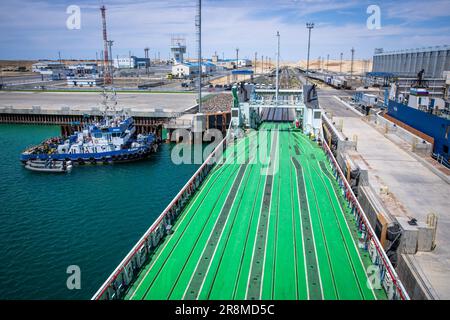 Kuryk, Kasachstan. 21. Juni 2023. Güterwagen mit Containern werden im Fährhafen Kuryk auf ein Fährschiff verladen und über das Kaspische Meer transportiert. Für den Güterverkehr zwischen Asien und Europa gewinnt der so genannte mittlere Korridor zunehmend an Bedeutung. Die Route verläuft durch Zentralasien und umgeht Russland im Norden und den Iran im Süden. Kredit: Jens Büttner/dpa/Alamy Live News Stockfoto