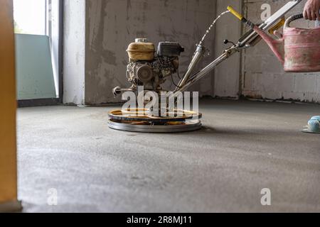 Professionelle Maschine zum Durchführen und Polieren von Sand- und Zementbodenboden auf der Baustelle Stockfoto