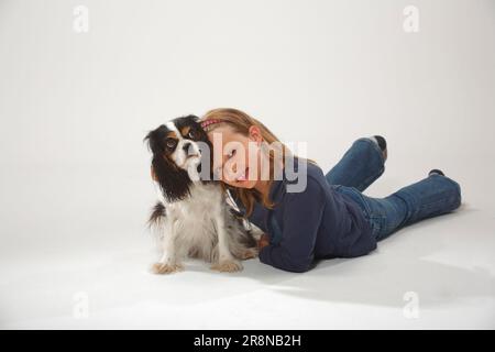 Mädchen mit Kavalier König Charles Spaniel, dreifarbig Stockfoto