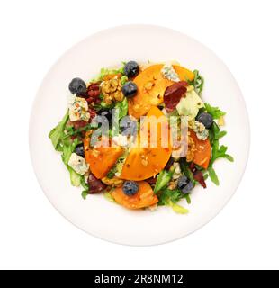 Köstlicher Persimonsalat mit Blaubeeren und Rucola isoliert auf weißem, Blick von oben Stockfoto