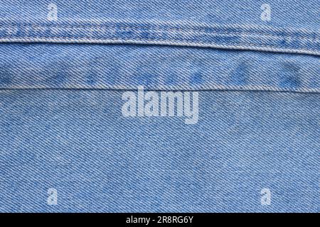 Denim-Material im Hintergrund mit Nähten, Denim-Struktur Stockfoto