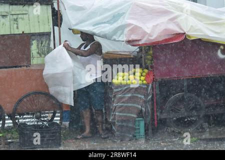 Ladenbesitzer organisieren ihre Geschäfte bei starkem Regen in Agartala. Tripura, Indien. Stockfoto