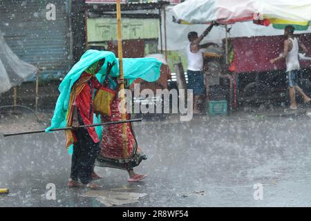 Pendler begeben sich bei starkem Regen in Agartala auf eine bewässerte Straße. Tripura, Indien. Stockfoto