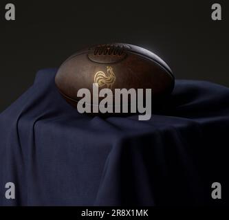 Eine 3D-Darstellung eines Rugby-Balls aus altem Leder mit goldenem Rugby-Logo auf einem marineblauen Stoff - 13. Februar 2023 in Bristol, Großbritannien Stockfoto