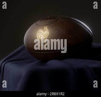 Eine 3D-Darstellung eines Rugby-Balls aus altem Leder mit goldenem Rugby-Logo auf einem marineblauen Stoff - 13. Februar 2023 in Bristol, Großbritannien Stockfoto